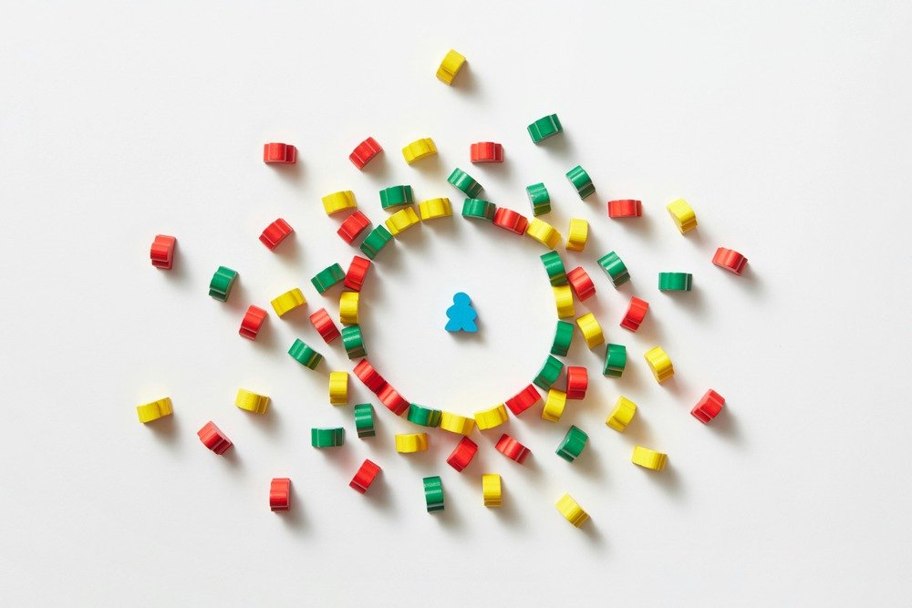 Lots of colored blocks surrounding one blue block in shape of a person