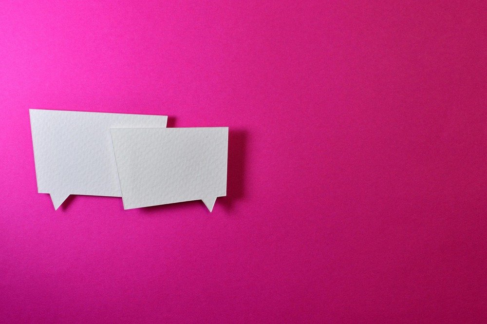 Pink wall with speech bubbles taped to the wall