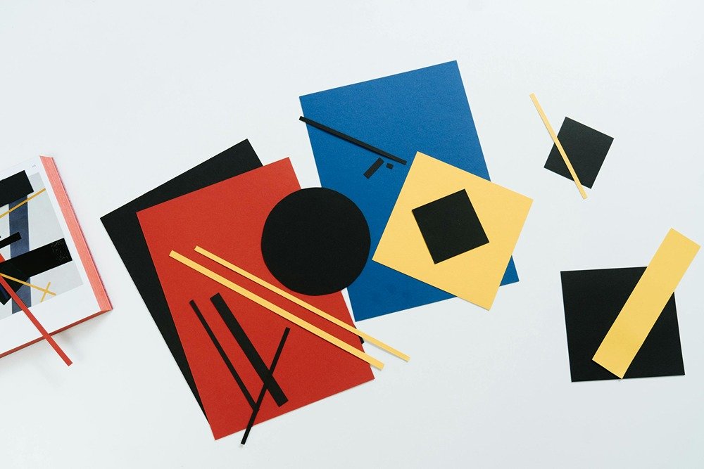 lots of different colored paper pieces, cut in different sizes, scattered on floor